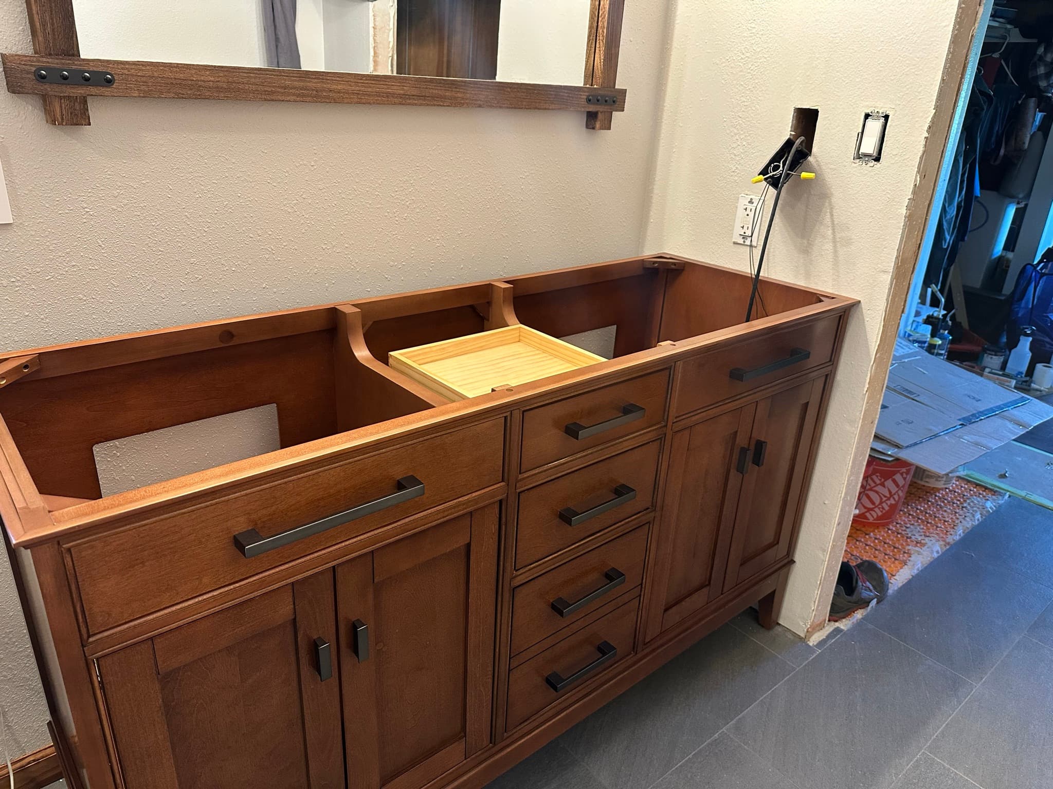 Top-down view of the same vanity cabinet from inside, showing the open top, drawer carcasses, and matte-black hardware.